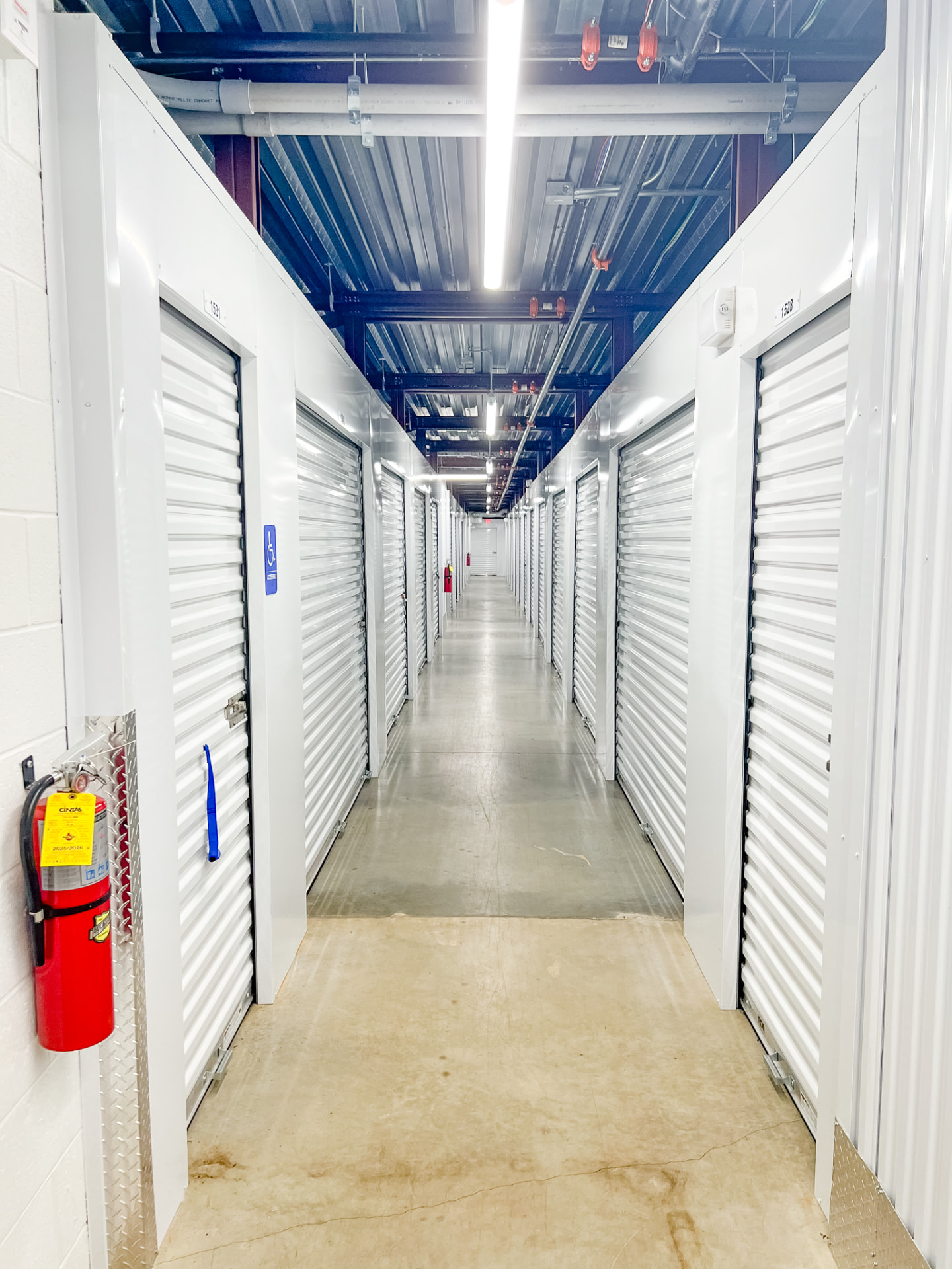 Interior climate-controlled storage corridor with roll-up unit doors